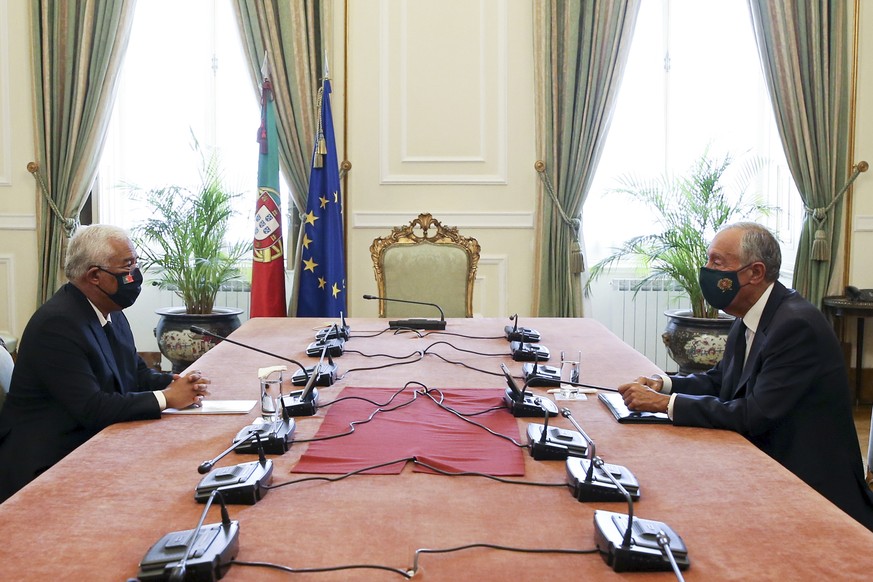 Portuguese Prime Minster Antonio Costa, left, meets with Portuguese President Marcelo Rebelo de Sousa at the Belem presidential palace in Lisbon Monday, Nov. 2, 2020. The country is introducing new re ...