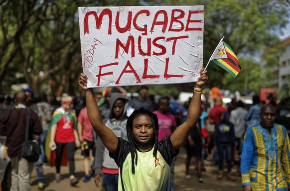 Protesters demanding President Robert Mugabe stands down march towards State House in Harare, Zimbabwe Saturday, Nov. 18, 2017. In a euphoric gathering that just days ago would have drawn a police cra ...