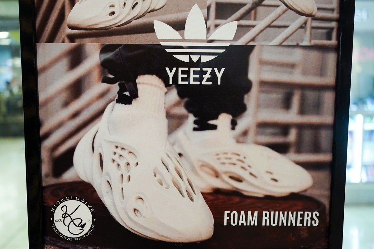 FILE - A sign advertises Yeezy shoes made by Adidas at Kickclusive, a sneaker resale store, in Paramus, N.J., on Oct. 25, 2022. Adidas said Friday, May 19, 2023, that it will begin selling its more th ...