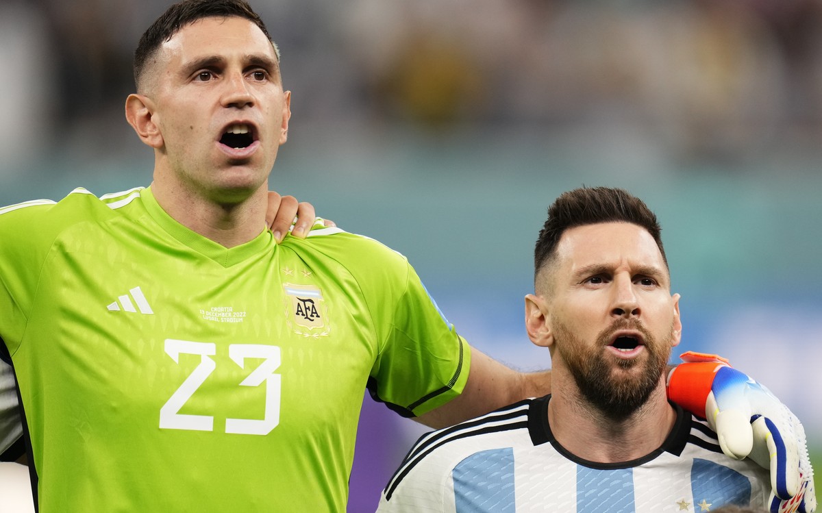 Argentina's goalkeeper Emiliano Martinez and Lionel Messi sing national anthem before the World Cup semifinal soccer match between Argentina and Croatia at the Lusail Stadium in Lusail, Qatar, Tu ...