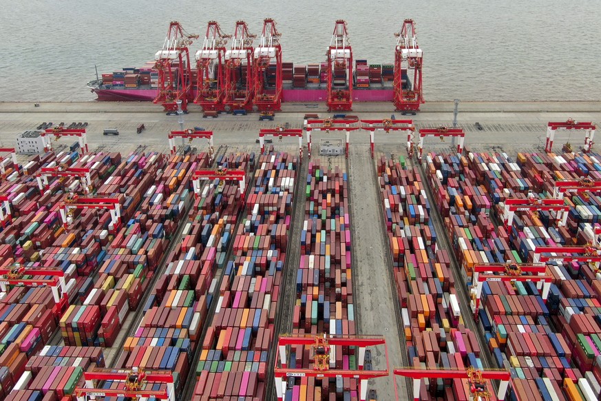 This aerial view shows the Yangshan container port in Shanghai, Saturday, July 10, 2021. China&#039;s exports surged in June while import growth slowed to a still-robust level as its economic rebound  ...