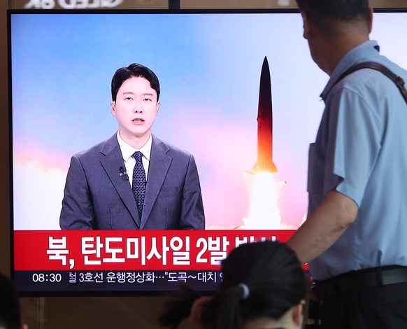 epa11449082 People watch the news coverage on North Korea&#039;s launch of two ballistic missiles at Seoul Station in Seoul, South Korea, 01 July 2024. According to the Joint Chiefs of Staff (JCS), on ...