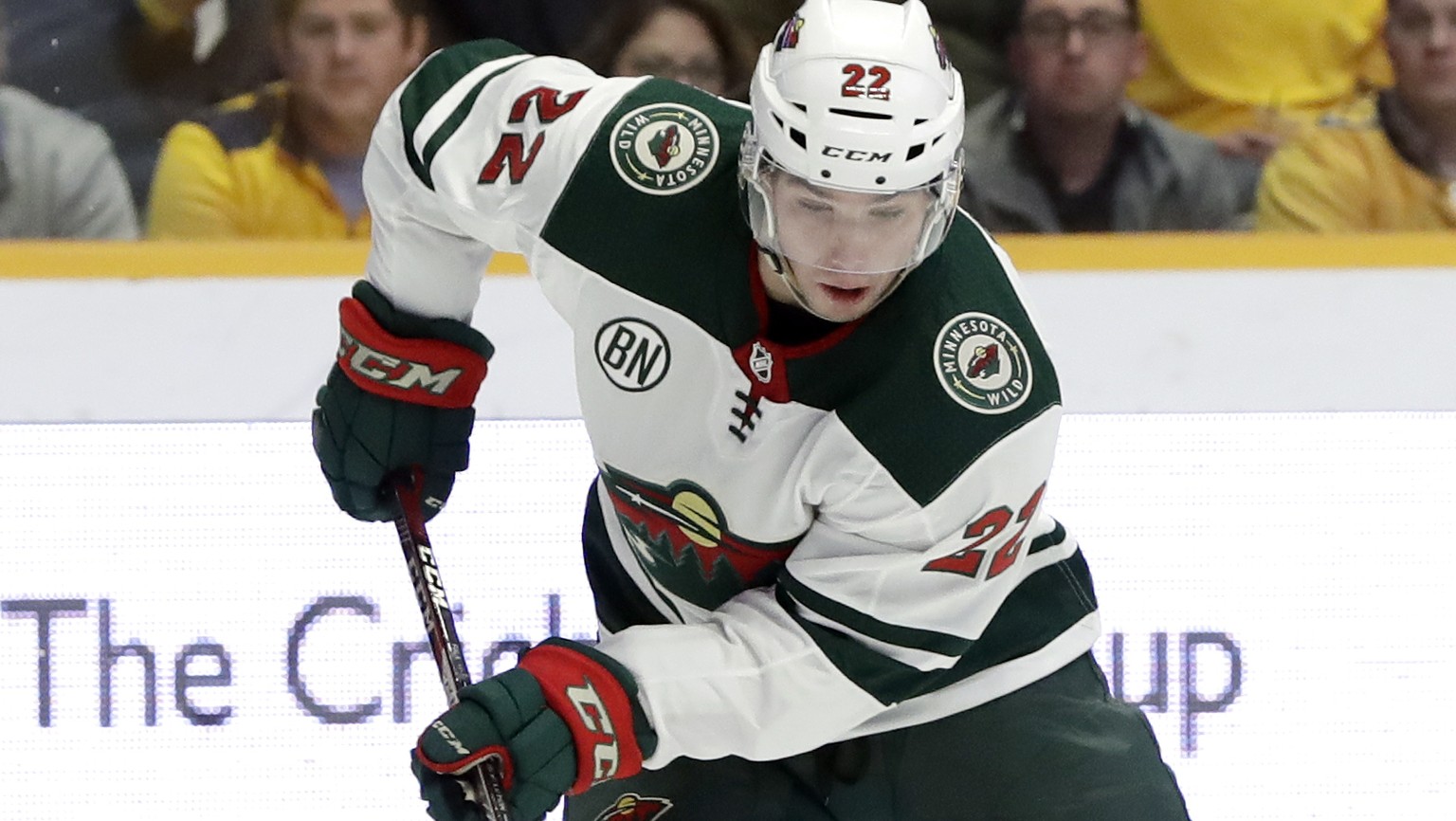 Minnesota Wild right wing Kevin Fiala (22), of Switzerland, moves the puck past Nashville Predators left wing Filip Forsberg (9), of Sweden, in the first period of an NHL hockey game Tuesday, March 5, ...