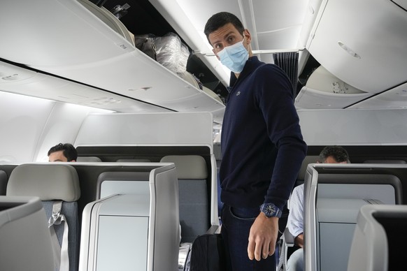 Novak Djokovic prepares to take his seat on a plane to Belgrade, in Dubai, United Arab Emirates, Monday, Jan. 17, 2022. Djokovic was deported from Australia on Sunday after losing a bid to stay in the ...