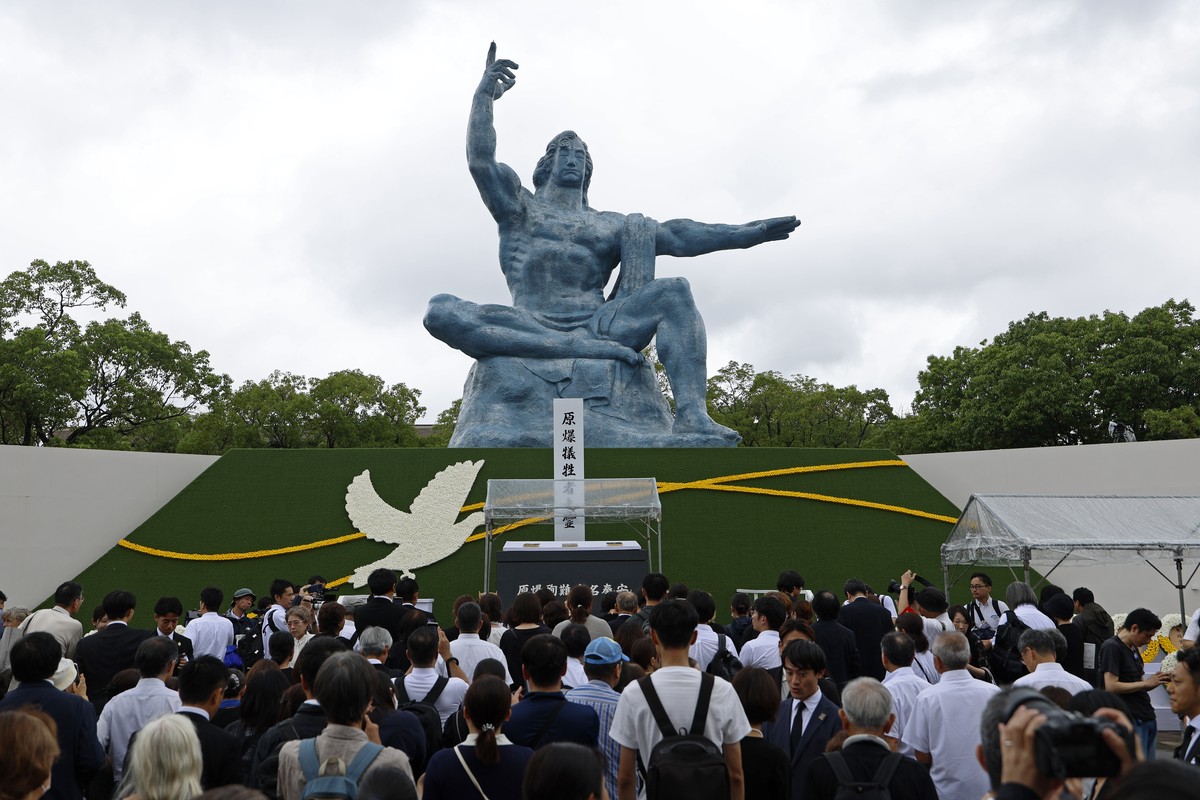 epa12290680 People gather before the Peace Statue following the 80th Nagasaki Peace Ceremony at the Peace Park in Nagasaki, southwestern Japan, 09 August 2025. In 1945, the United States dropped two n ...