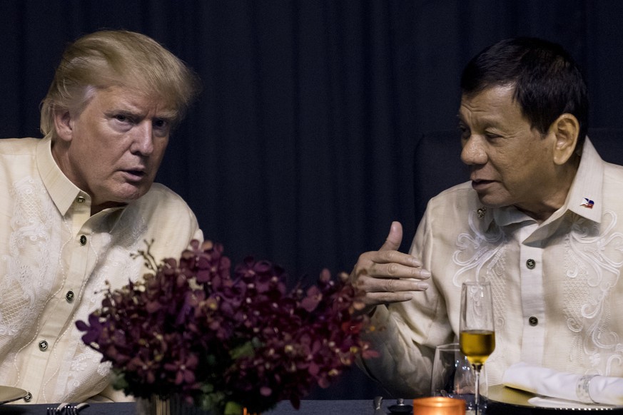 President Donald Trump speaks with Philippines President Rodrigo Duterte, right, at an ASEAN Summit dinner at the SMX Convention Center, Sunday, Nov. 12, 2017, in Manila, Philippines. (AP Photo/Andrew ...