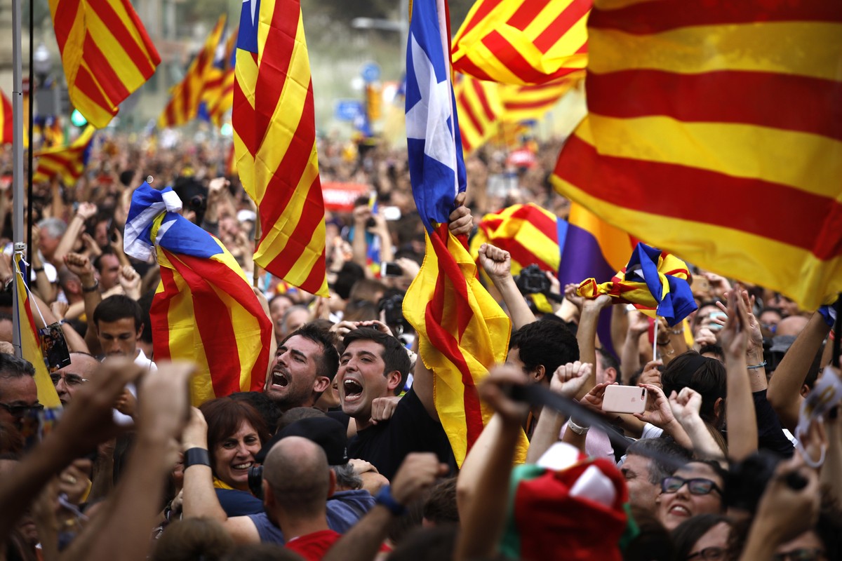 People react as they celebrate the unilateral declaration of independence of Catalonia outside the Catalan Parliament, in Barcelona, Spain, Friday, Oct. 27, 2017. Catalonias' regional Parliament  ...