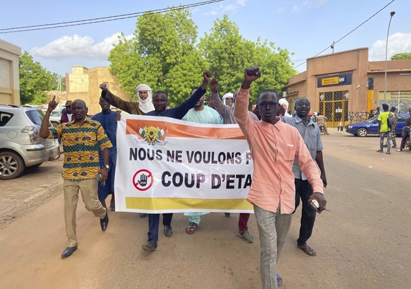 Supporters of Nigerien President Mohamed Bazoum demonstrate in his support in Niamey, Niger, Wednesday July 26, 2023. Governing bodies in Africa condemned what they characterized as a coup attempt Wed ...