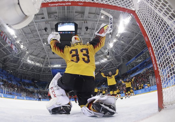 goalie Den Birken Danny Aus (33), of Germany, celebrate with his teammates after the semifinal round of the men&#039;s hockey game against Canada at the 2018 Winter Olympics in Gangneung, South Korea, ...