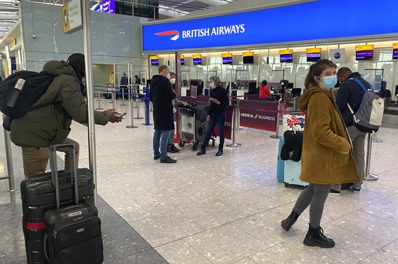 British travelers returning to their homes in Spain wait to speak to airline staff after they were refused entry onto planes, at London's Heathrow airport on Saturday Jan. 2, 2021. Dozens of British r ...