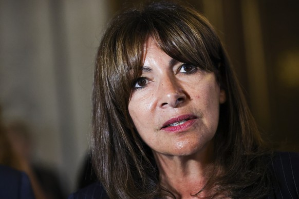 epa11563652 The mayor of Paris Anne Hidalgo speaks with the press before the beginning of commemoration to pay tribute to the Spanish Republicans division La Nueve, in Paris, France, 24 August 2024. T ...