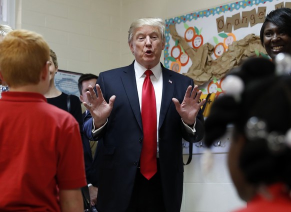 President Donald Trump talks to children in Jane Jones fourth grade class during a tour of Saint Andrew Catholic School, Friday, March 3, 2017, in Orlando, Fla. (AP Photo/Alex Brandon)