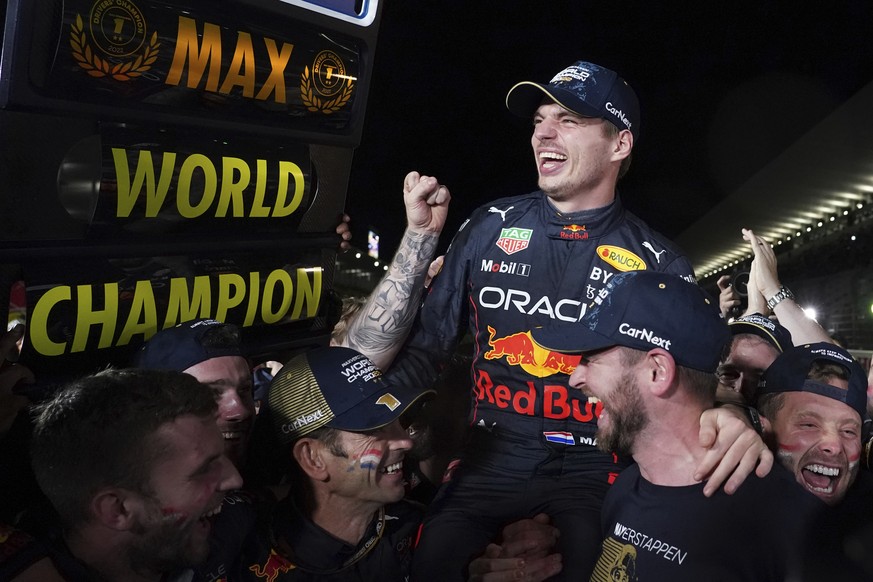 Red Bull driver Max Verstappen of the Netherlands celebrates with teammates as he became F1 drivers world champion, during the Japanese Formula One Grand Prix at the Suzuka Circuit in Suzuka, central  ...