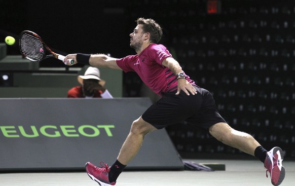 Stan Wawrinka, of Switzerland, reaches for the ball against Malek Jaziri, of Tunisia, during the Miami Open tennis tournament, Monday, March 27, 2017, in Key Biscayne, Fla. (AP Photo/Luis M. Alvarez)