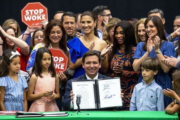 FILE �?? Florida Gov. Ron DeSantis reacts after publicly signing HB7, &quot;individual freedom,&quot; also dubbed the &quot;stop woke&quot; bill during a news conference at Mater Academy Charter Middl ...