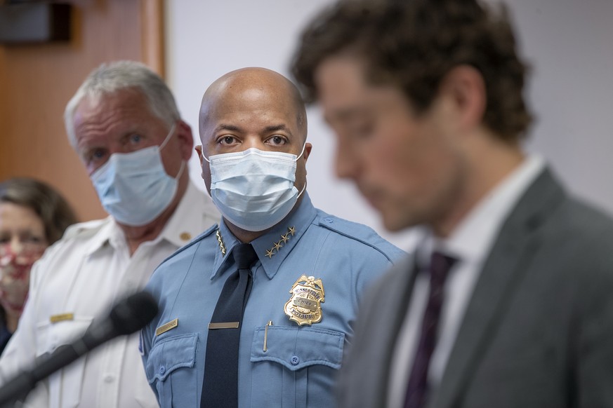 Minneapolis Police Chief Medaria Arradondo, left, listens as Minneapolis Mayor Jacob Frey becomes emotional during a news conference Thursday, May 28, 2020 in Minneapolis, Minn. Violent protests over  ...