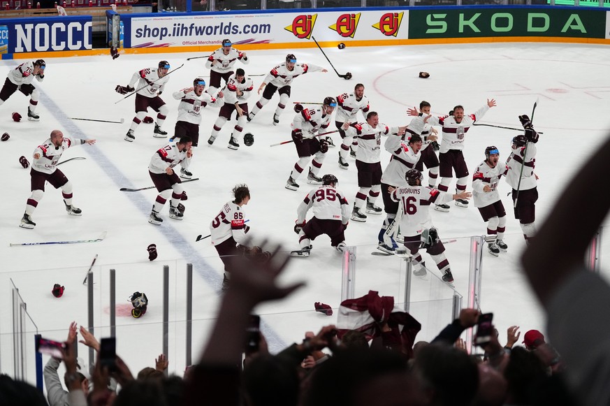 Latvia celebrates their game winning goal in overtime over the United States in their bronze medal match at the Ice Hockey World Championship in Tampere, Finland, Sunday, May 28, 2023. Latvia won 4-3. ...