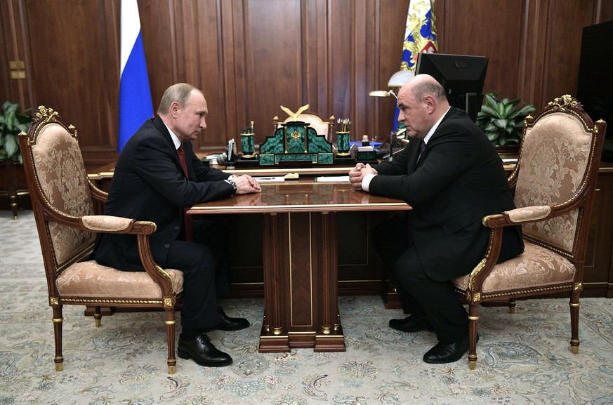 Russian President Vladimir Putin, left, listens to Tax Service chief Mikhail Mishustin during their meeting in the Kremlin in Moscow, Russia, Wednesday, Jan. 15, 2020. Putin has named Tax Service chie ...