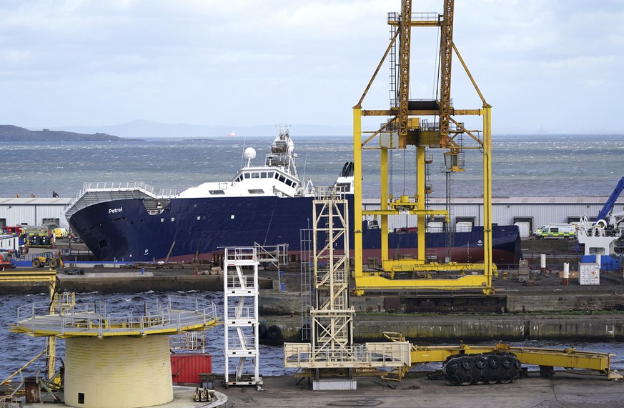 Emergency services work at Imperial Dock, where a ship has become dislodged from its holding and is partially toppled over, in Leith, Edinburgh, Scotland, Wednesday March 22, 2023. (Andrew Milligan/PA ...