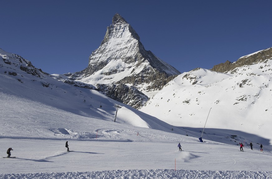 FILE - Skiers ride down the slopes at Riffelberg with Mount Matterhorn in the background, on Jan. 16, 2012, in Zermatt in the canton of Valais, Switzerland. An American teenager and two other people w ...