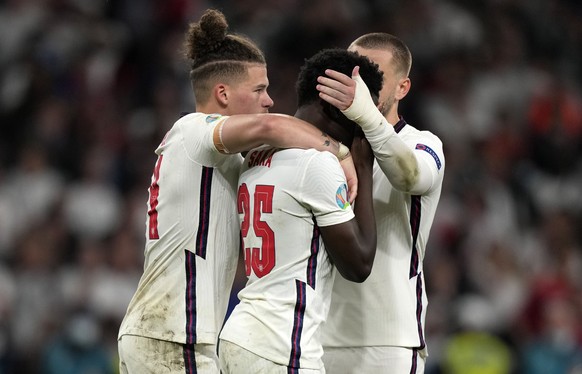 epa09338891 Bukayo Saka (C) of England is consoled by teammates after the UEFA EURO 2020 final between Italy and England in London, Britain, 11 July 2021. EPA/Frank Augstein / POOL (RESTRICTIONS: For  ...