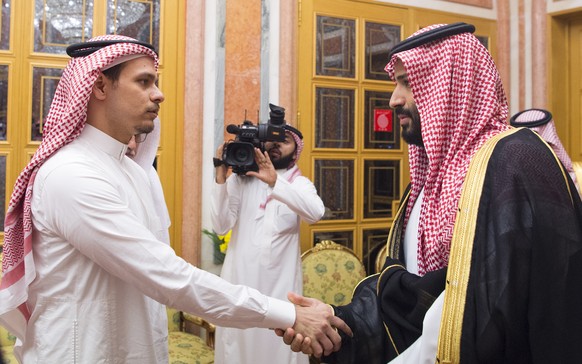 epa07113469 A handout photo made available by the Saudi Royal Palace shows Saudi Crown Prince Mohammed bin Salman (R) meeting with Salah bin Jamal Khashoggi (L), son of late Saudi journalist Jamal Kha ...