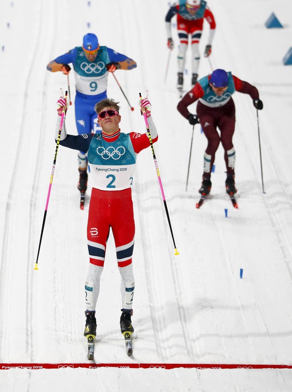 Johannes Hoesflot Klaebo, of Norway, celebrates after winning the men&#039;s cross-country skiing sprint classic at the 2018 Winter Olympics in Pyeongchang, South Korea, Tuesday, Feb. 13, 2018. (AP Ph ...