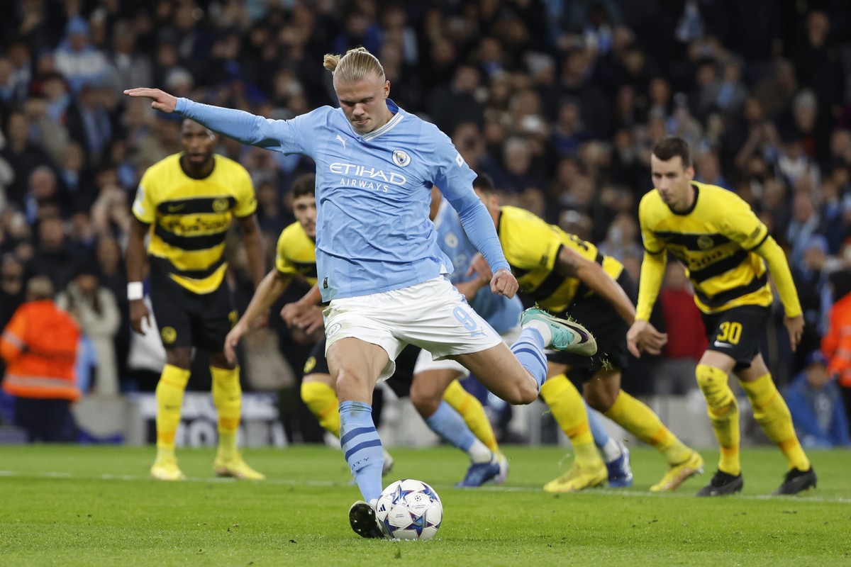 Manchester City's Erling Haaland scores his sides first goal with a penalty shot during the Champions League group stage match between Manchester City of England and BSC Young Boys of Switzerland ...