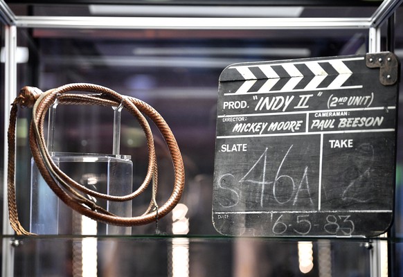 epa07000528 A whip and a clapperboard from the film Indiana Jones and the Temple of Doom at a media preview for at television and film memorabilia auction by Prop Store. in London, Britain, 06 Septemb ...