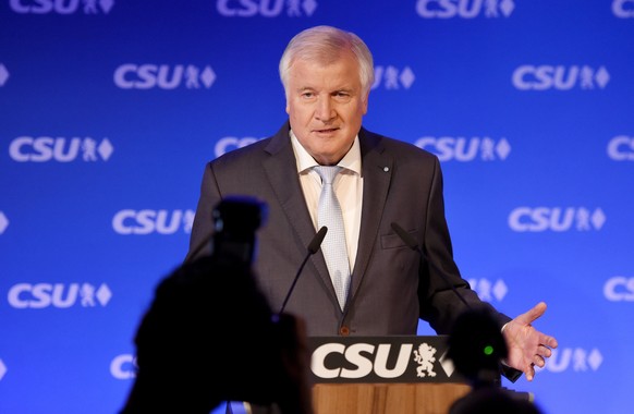 epa06224449 Horst Seehofer, Bavarian Prime Minister and chairman of the German Christian Social Union (CSU) party, reacts to the first prognosis of German federal election at the CSU election event in ...