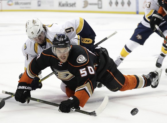 Anaheim Ducks&#039; Antoine Vermette, front, and Nashville Predators&#039; Filip Forsberg, of Sweden, fall to the ice as they fight for the puck during the first period of an NHL hockey game Wednesday ...