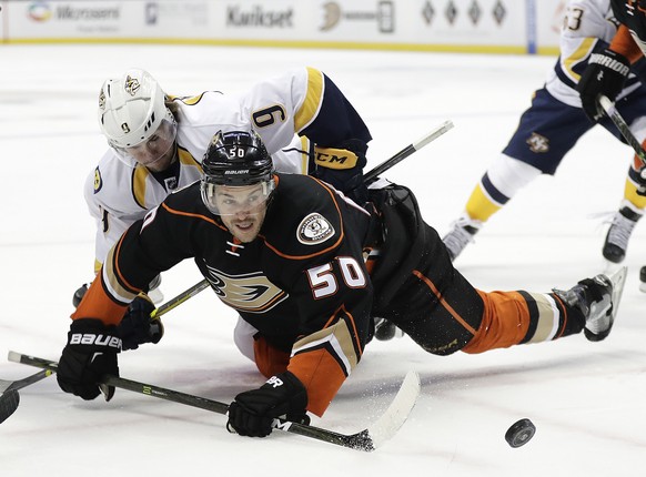 Anaheim Ducks&#039; Antoine Vermette, front, and Nashville Predators&#039; Filip Forsberg, of Sweden, fall to the ice as they fight for the puck during the first period of an NHL hockey game Wednesday ...