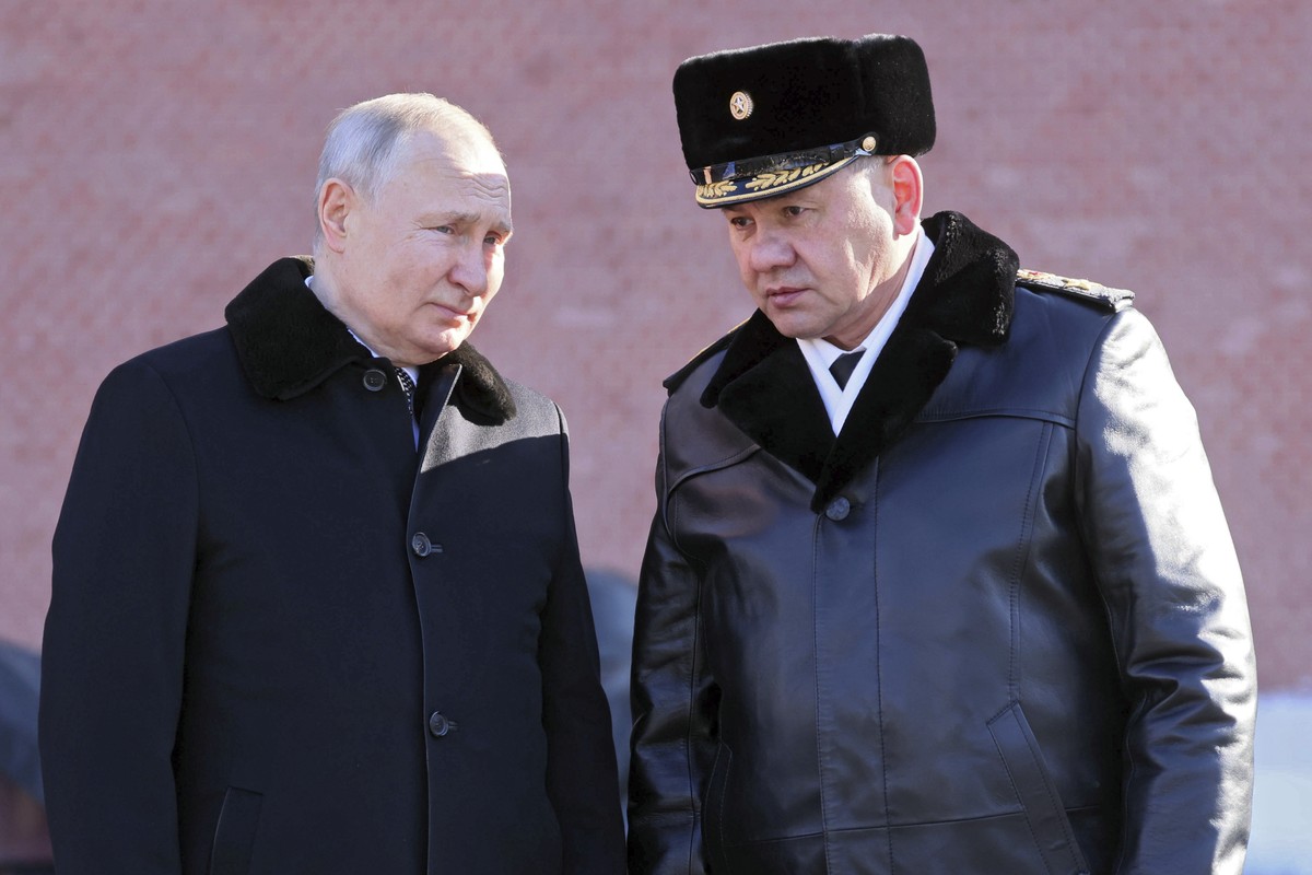 Russian President Vladimir Putin, left, and Russian Defence Minister Sergei Shoigu attend a wreath-laying ceremony at the Unknown Soldier's Grave in the Alexander Garden during the national celeb ...
