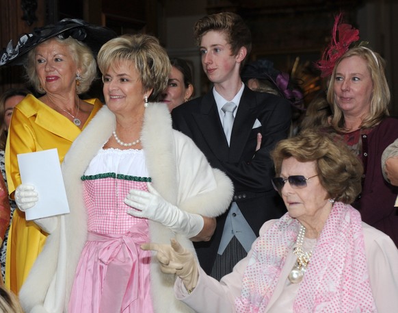 Princess Gloria von Thurn und Taxis (R) and her mother Countess Beatrix of Schönburg-Glauchau (R) and other guests leave after the wedding of German Princess Maria Theresia von Thurn und Taxis and Bri ...