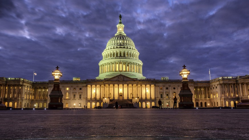 FILE - In this Jan. 21, 2018, file photo, lights shine inside the U.S. Capitol Building as night falls in Washington. President Donald Trump will herald a robust economy and push for bipartisan congre ...