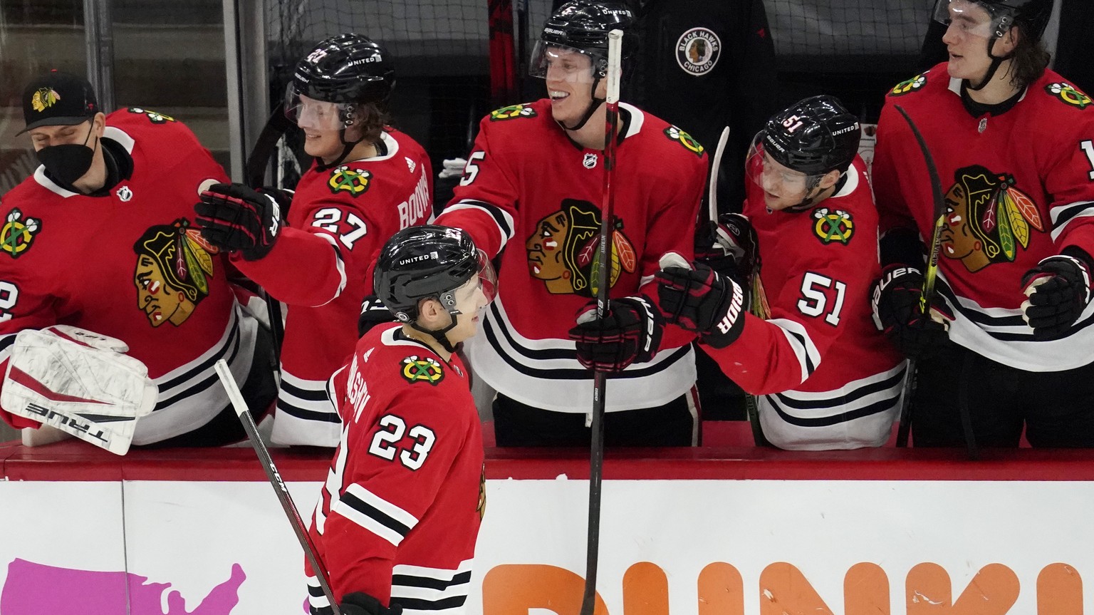 Chicago Blackhawks&#039; Philipp Kurashev (23) celebrates with teammates after scoring a goal in a shootout of an NHL hockey game against the Tampa Bay Lightning in Chicago, Friday, March 5, 2021. (AP ...