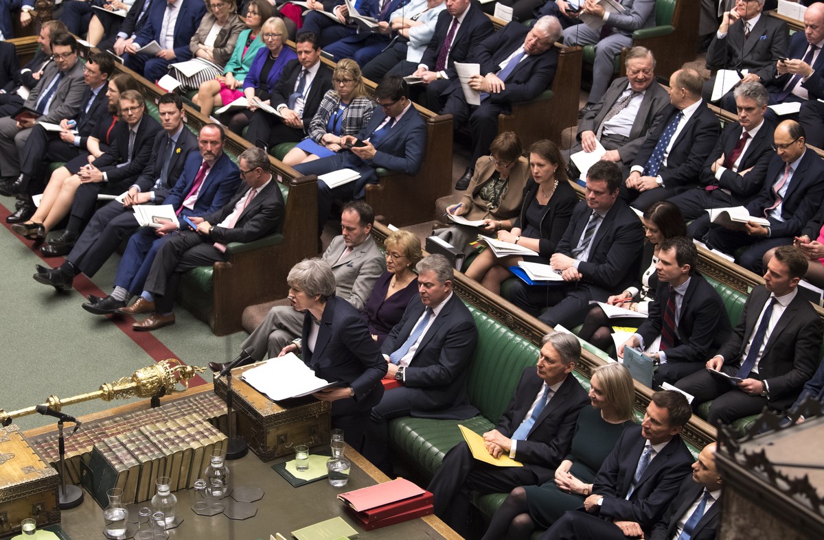 Britain's Prime Minister Theresa May at center right front row, speaks to lawmakers in the House of Commons, London, Wednesday March 13, 2019. Political crisis in Britain is sparking anxiety acro ...