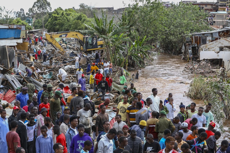 epa11317130 Locals of the Ngondo village, try to salvage some of their belongings as their houses get demolished by a government multiagency including the Kenyan military for being constructed along t ...