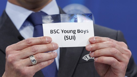 UEFA Senior Competitions Director, Tom Barlow, displays the ticket of the Swiss club BSC Young Boys, during the draw for the 2023/24 UEFA Champions League play-off round, at the UEFA headquarters in Nyon, Switzerland...