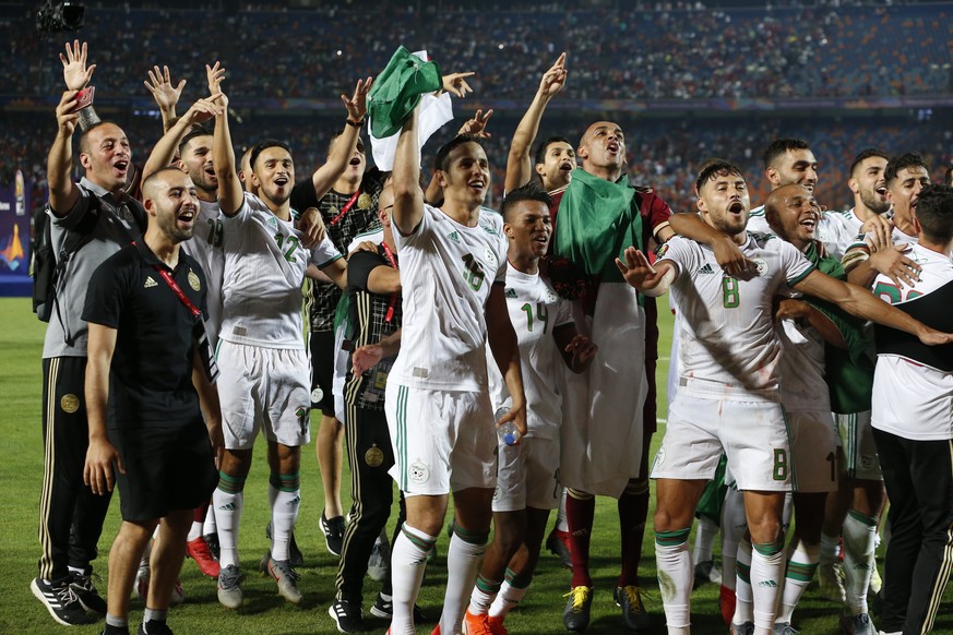 Algerian players celebrate after the African Cup of Nations final soccer match between Algeria and Senegal in Cairo International stadium in Cairo, Egypt, Friday, July 19, 2019. (AP Photo/Ariel Schali ...