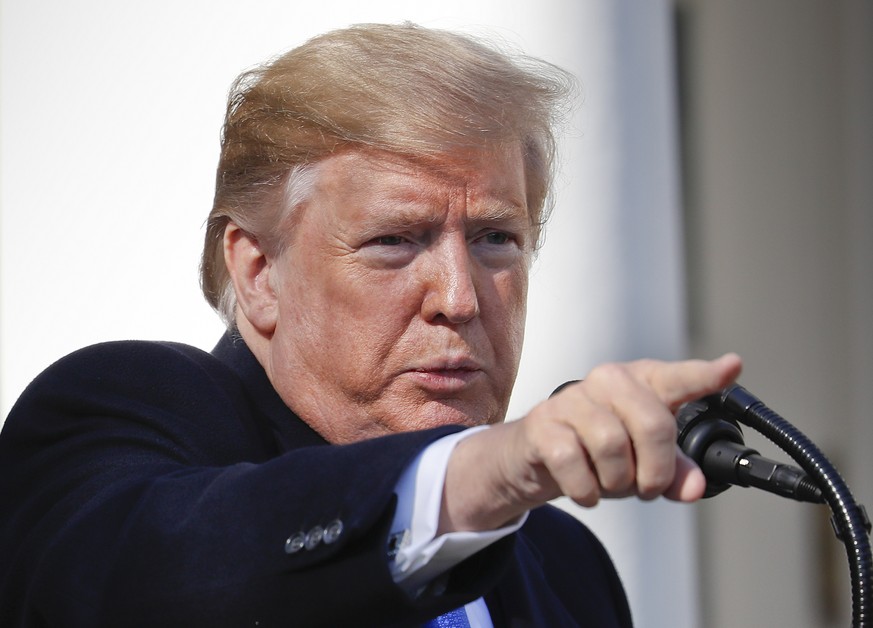 President Donald Trump points to a member of the media while taking questions after speaking during an event in the Rose Garden at the White House to declare a national emergency in order to build a w ...