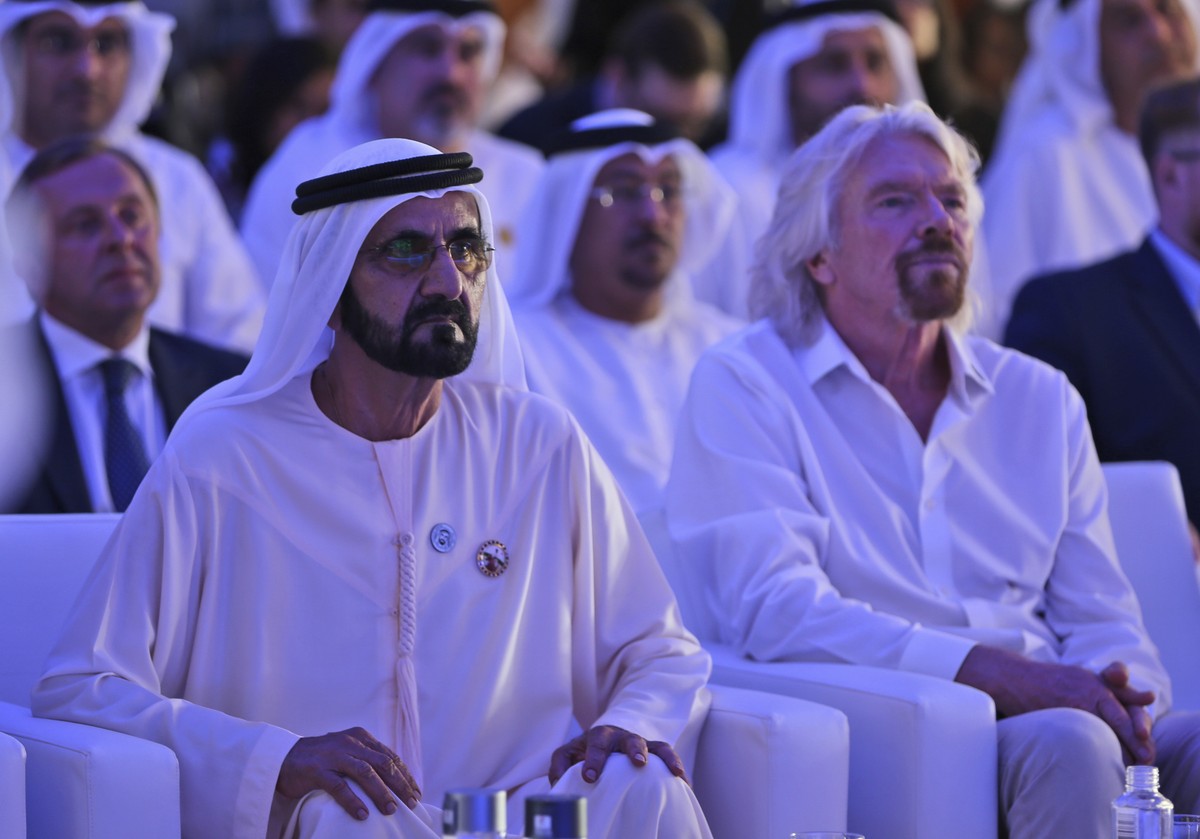 Dubai ruler Sheikh Mohammed bin Rashid Al Maktoum, the Emirates' vice president and prime minister, left, next to Richard Branson watch the Hyperloop One presentation aboard the Queen Elizabeth 2 ...