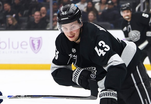 Los Angeles Kings defenseman Jacob Moverare (43) skates with the puck against Vancouver Canucks right wing Jonathan Lekkerimäki, left, as Los Angeles Kings defenseman Cody Ceci (5) watches during the  ...