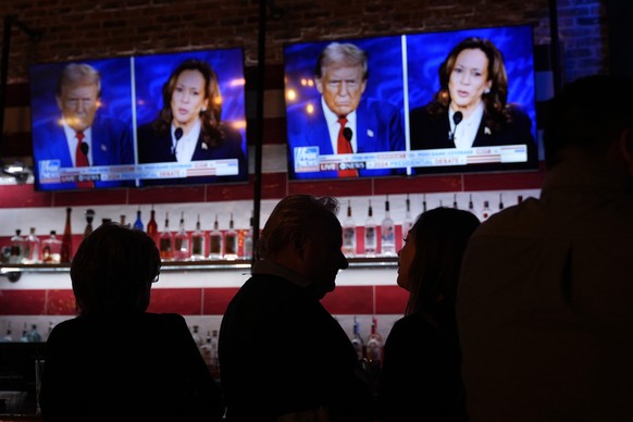 Viewers gather to watch a debate between Democratic presidential nominee Vice President Kamala Harris and Republican presidential nominee former President Donald Trump at the Angry Elephant Bar and Gr ...