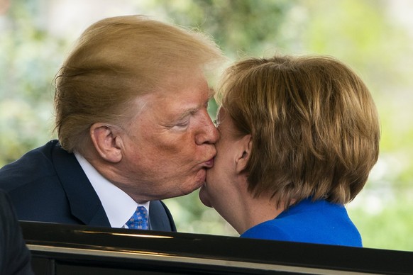 epa06697218 US President Donald J. Trump (L) greets Chancellor of Germany Angela Merkel (R) at the West Wing of the White House in Washington, DC, USA, 27 April 2018. Merkel is on a one-day working vi ...