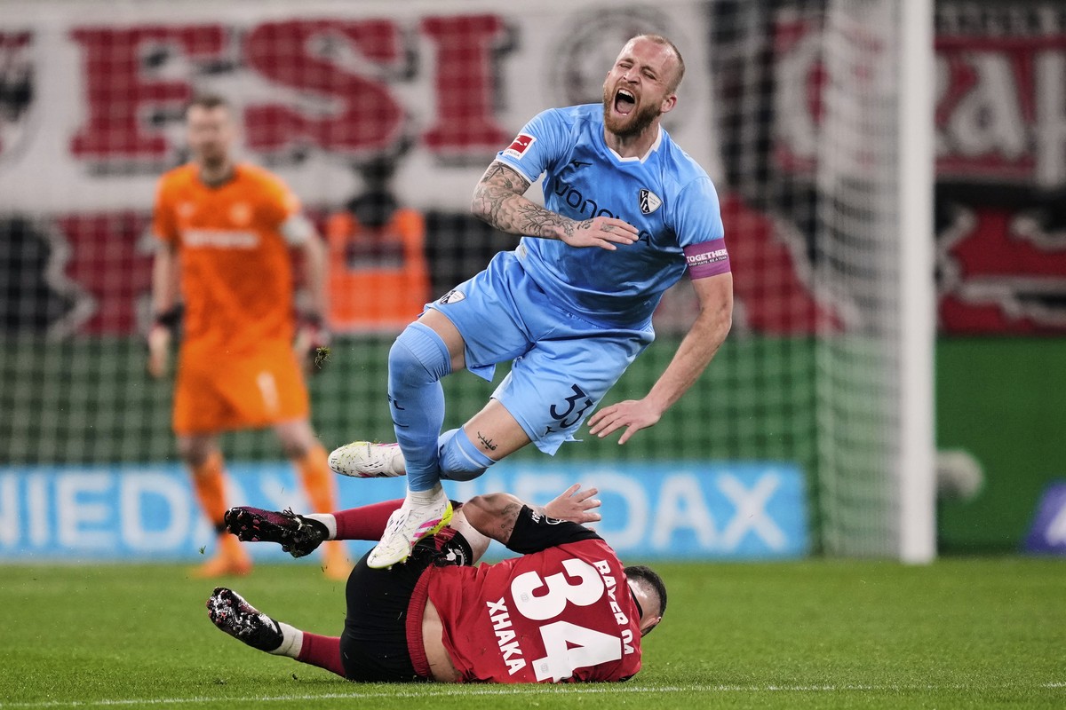 Leverkusen's Granit Xhaka and Bochum's Philipp Hofmann, up, challenge during the German Bundesliga soccer match between Bayer Leverkusen and VfL Bochum at the BayArena in Leverkusen, Germany ...