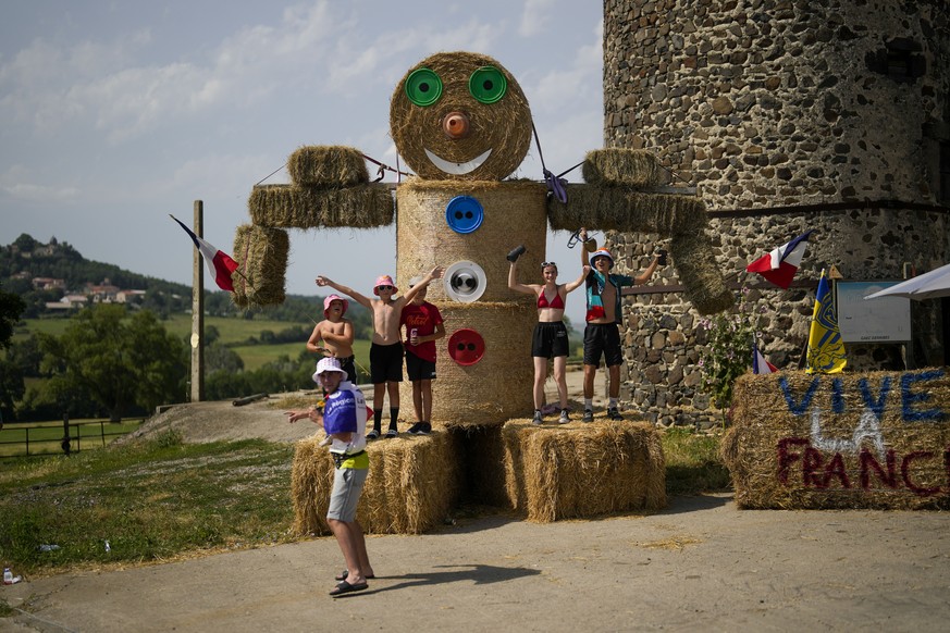 Spectators wait for the riders to pass during the tenth stage of the Tour de France cycling race over 167 kilometers (104 miles) with start in Vulcania and finish in Issoire, France, Tuesday, July 11, ...