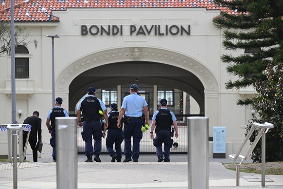 epa12592768 Police at the scene where two gunmen opened fire at Bondi Beach in Sydney, Australia, 15 December 2025. Australia is in mourning after gunmen opened fire on Bondi Beach, killing 16 people  ...