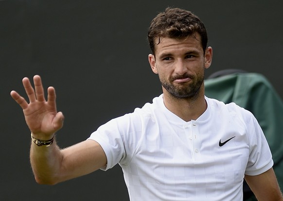 epa06075679 Grigor Dimitrov of Bulgaria celebrates winning against Dudi Sela of Israel (who retired) during their third round match for the Wimbledon Championships at the All England Lawn Tennis Club, ...