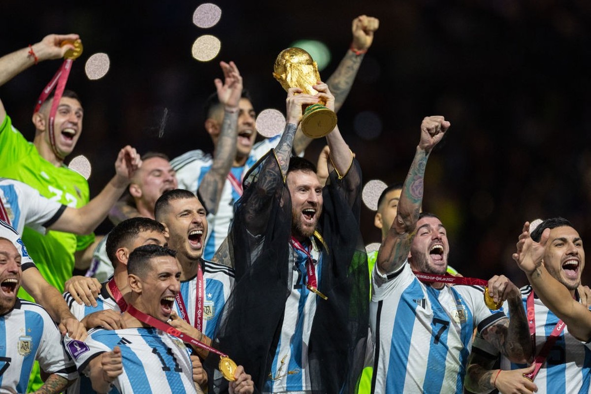 LUSAIL CITY, QATAR - DECEMBER 18: Lionel Messi of Argentina lifts the FIFA World Cup trophy alongside his teammates during the trophy presentation following the FIFA World Cup Qatar 2022 Final match b ...